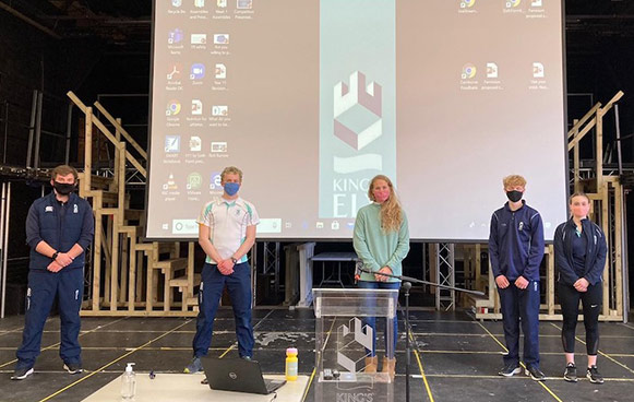 children standing infront of a board